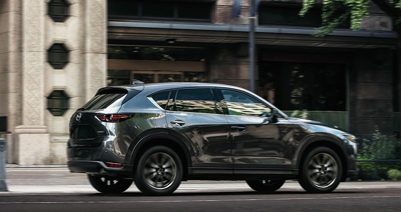 Grey 2020 Mazda CX-5 Driving on the road | Parkway Family Mazda in Kingwood, TX