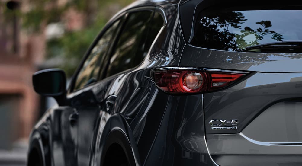 The badging on the back of a charcoal 2020 Mazda CX-5 from a Mazda dealer is shown.