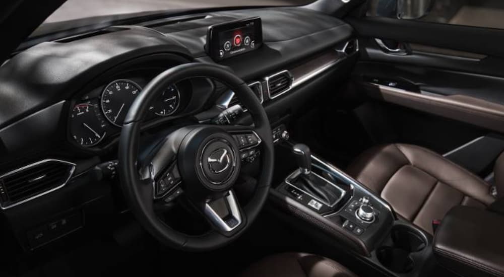 The black and brown interior of a 2020 Mazda CX-5 is shown.