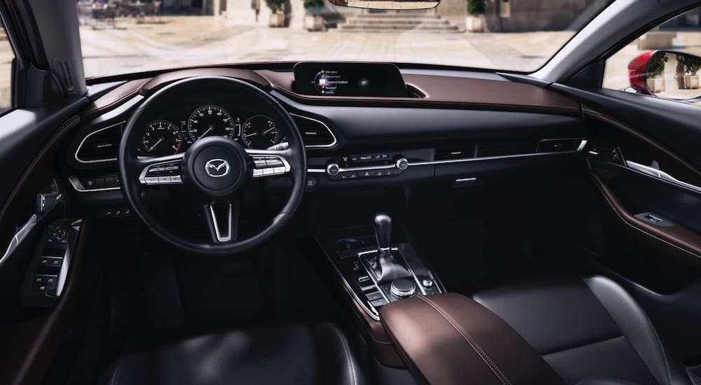 The brown and gray dashboard of a 2021 Mazda CX-30 is shown at a Houston Mazda dealership.