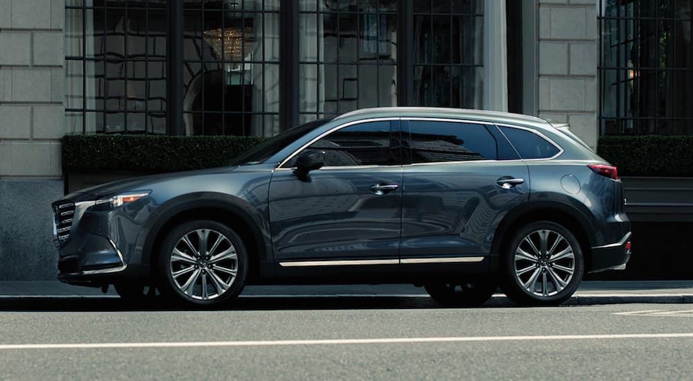 A grey 2021 Mazda CX-9 is parked on a city street.