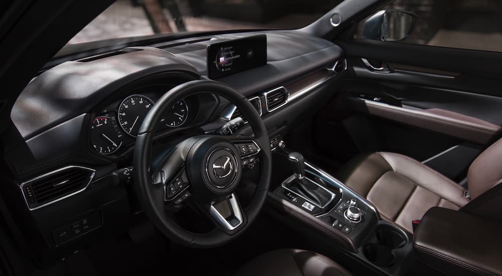 The black interior and infotainment system is shown from a high and in a 2021 Mazda CX-5.